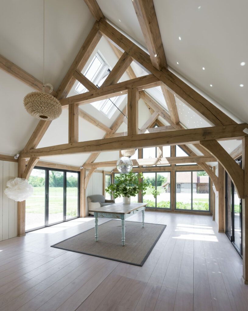 room with oak frame and vaulted ceiling