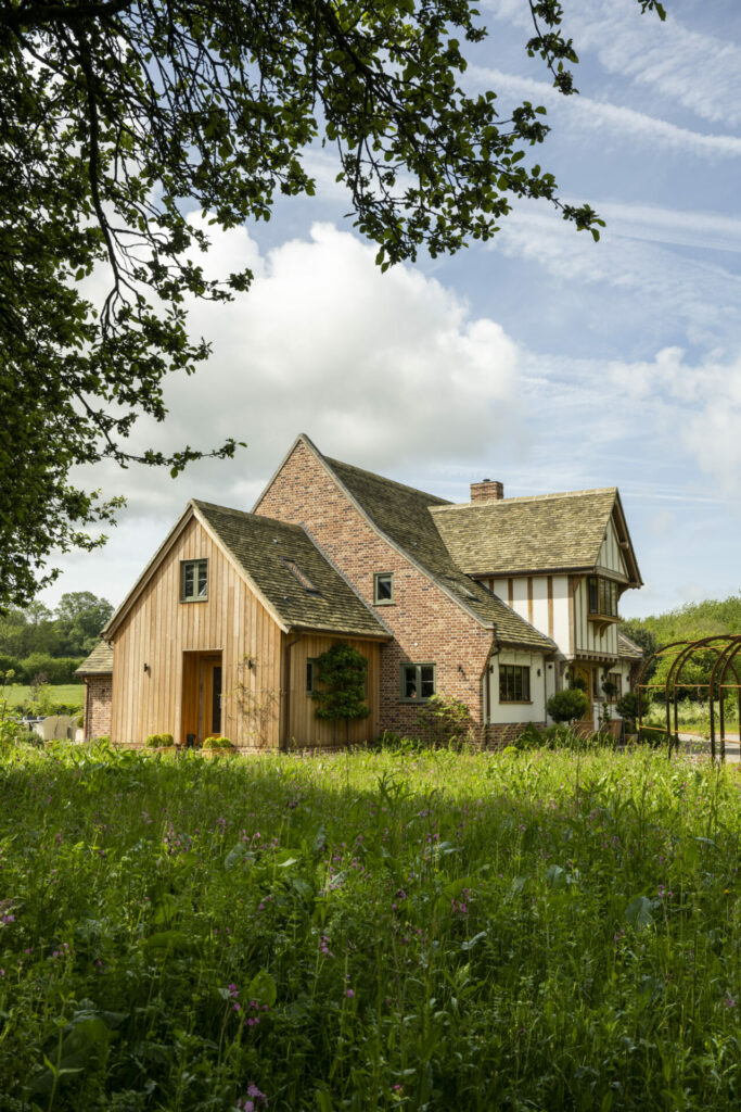 Side view of oak frame country home and garden