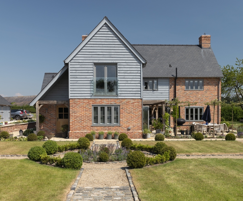 Rear of brick and weatherboard house in the countryside
